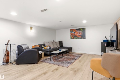 This versatile room features light-toned flooring, white walls, and recessed lighting - 18315 68 Avenue, Edmonton, AB - Indoor