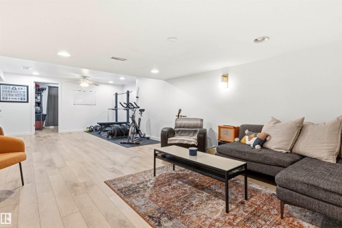 The property features light-toned flooring, recessed lighting, and a ceiling fan - 18315 68 Avenue, Edmonton, AB - Indoor