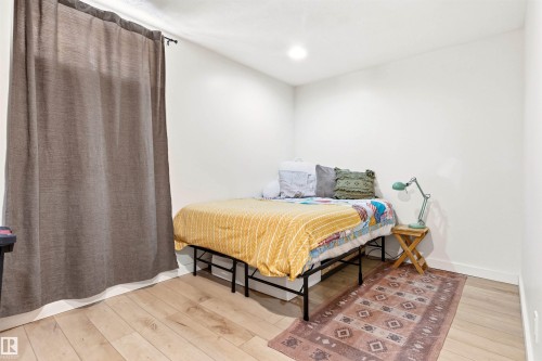 This room features light-toned wood flooring and recessed lighting - 18315 68 Avenue, Edmonton, AB - Indoor Photo Showing Bedroom