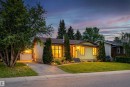 The property features a well-maintained lawn, mature trees, and a driveway leading to a garage - 18315 68 Avenue, Edmonton, AB  - Outdoor 