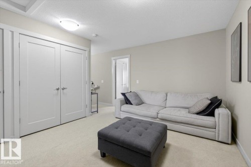 Living area featuring neutral-toned walls and carpet, with recessed lighting - 16656 14 Avenue, Edmonton, AB - Indoor Photo Showing Living Room