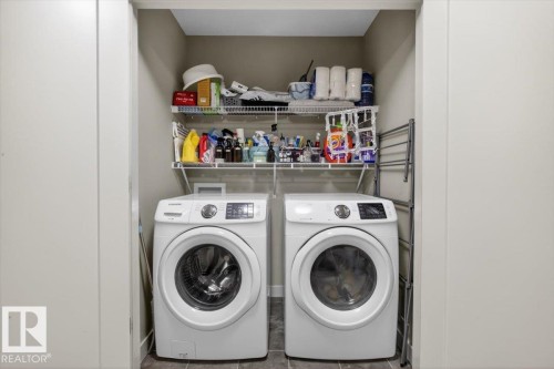 Laundry area with a front-loading washer and dryer, featuring white wire shelving - 16656 14 Avenue, Edmonton, AB - Indoor Photo Showing Laundry Room