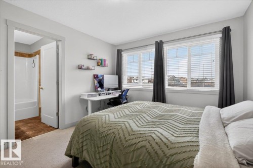 The room features light-colored walls and carpeted flooring - 16656 14 Avenue, Edmonton, AB - Indoor Photo Showing Bedroom