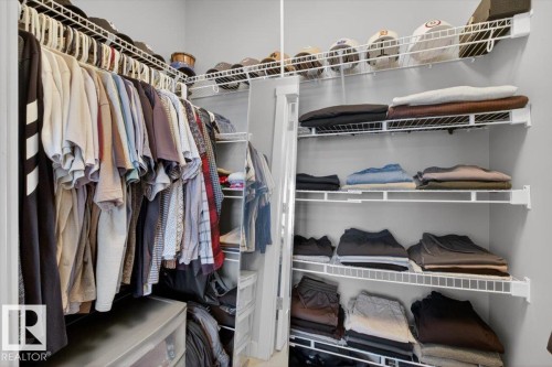 The property features a walk-in closet with ample storage, including wire shelving and a hanging rod system - 16656 14 Avenue, Edmonton, AB - Indoor With Storage