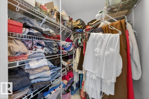Well-appointed closet featuring wire shelving and hanging rods - 16656 14 Avenue, Edmonton, AB - Indoor With Storage
