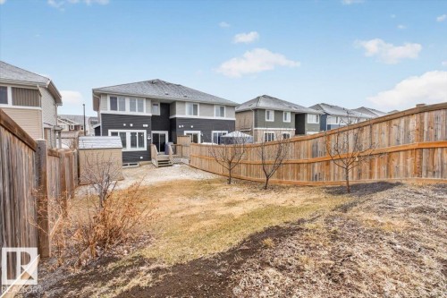 The property features a spacious backyard with a wooden privacy fence and a shed - 16656 14 Avenue, Edmonton, AB - Outdoor