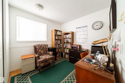 This room features white walls, a white window blind, and a patterned green area rug - 1104 35 Street, Edmonton, AB - Indoor Photo Showing Office