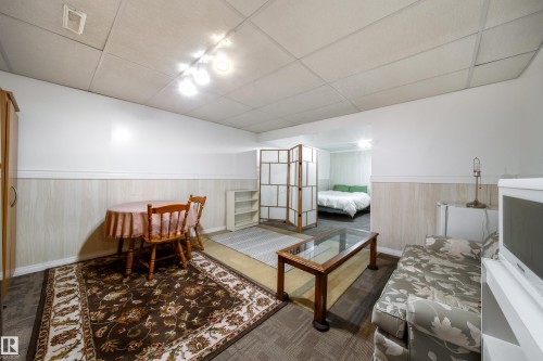 Spacious room featuring a drop ceiling, track lighting, and a neutral color palette - 1104 35 Street, Edmonton, AB - Indoor