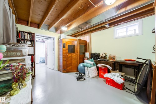 This room features exposed wooden ceiling beams and a window providing natural light - 1104 35 Street, Edmonton, AB - Indoor Photo Showing Basement