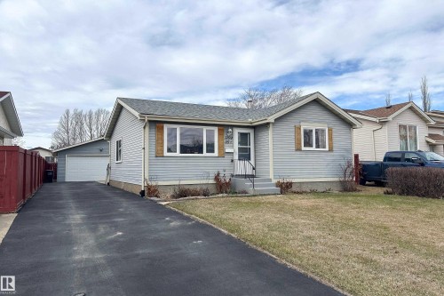 Light grey siding exterior with a dark grey shingled roof - 1104 35 Street, Edmonton, AB - Outdoor