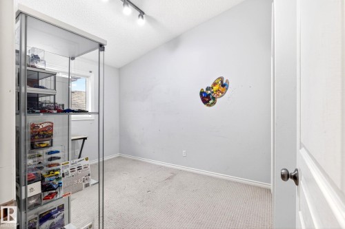 This room features a window providing natural light, a sloped ceiling, and track lighting - 20147 48 Avenue, Edmonton, AB - Indoor Photo Showing Other Room