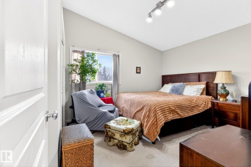 This room features a window providing natural light, carpeted flooring, and light-colored walls - 20147 48 Avenue, Edmonton, AB - Indoor Photo Showing Bedroom