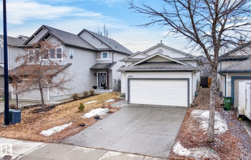 The property features a concrete driveway leading to an integrated garage - 20147 48 Avenue, Edmonton, AB - Outdoor With Facade