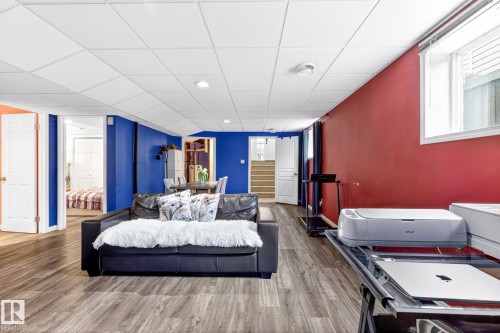 The property features a spacious room with wood-look flooring and a drop ceiling with recessed lighting - 20147 48 Avenue, Edmonton, AB - Indoor Photo Showing Bedroom