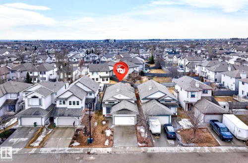 This aerial view captures the property's exterior, featuring a two-car garage and a paved driveway - 20147 48 Avenue, Edmonton, AB - Outdoor
