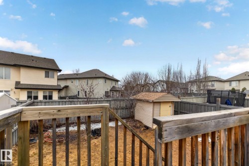 The property features a fenced yard, a wooden deck, and a storage shed with a shingled roof - 20147 48 Avenue, Edmonton, AB - Outdoor