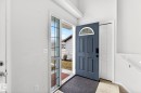 The property features a front entrance with a dark paneled door that includes a decorative arched window - 20147 48 Avenue, Edmonton, AB  - Indoor Photo Showing Other Room 