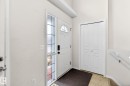 Entryway featuring a white door with a window, a sidelight, and a white bi-fold closet - 20147 48 Avenue, Edmonton, AB 