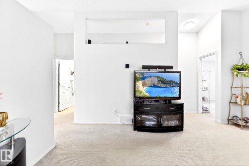 The property offers a bright interior with light-colored carpeting throughout, creating a neutral base - 20147 48 Avenue, Edmonton, AB - Indoor Photo Showing Other Room
