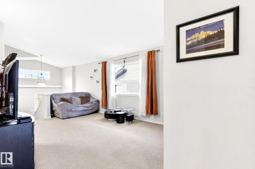 The living area features carpeted flooring and white walls - 20147 48 Avenue, Edmonton, AB - Indoor