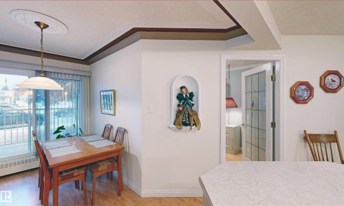 This dining area features a large window with vertical blinds, providing ample natural light - 31 9914 80 Avenue, Edmonton, AB - Indoor Photo Showing Dining Room