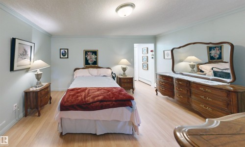 This room features light-colored flooring and light blue walls, creating a serene ambiance - 31 9914 80 Avenue, Edmonton, AB - Indoor Photo Showing Bedroom