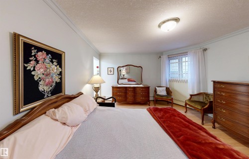 This room features light-colored walls, crown molding, and hardwood flooring - 31 9914 80 Avenue, Edmonton, AB - Indoor Photo Showing Bedroom