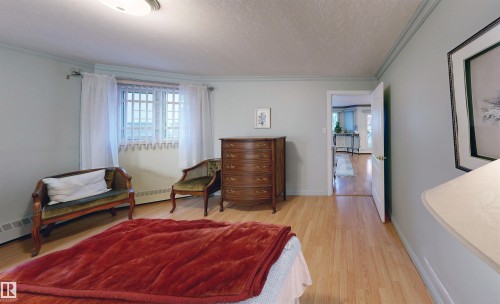 Room featuring wood flooring, light blue walls, and crown molding - 31 9914 80 Avenue, Edmonton, AB - Indoor Photo Showing Other Room