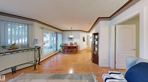 The property features light wood flooring throughout the main living areas - 31 9914 80 Avenue, Edmonton, AB - Indoor Photo Showing Living Room