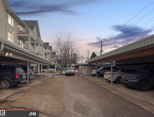 The property features covered parking areas, providing shelter for vehicles - 31 9914 80 Avenue, Edmonton, AB - Outdoor
