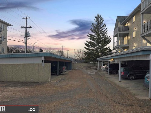 The property includes covered parking stalls, visible on both the left and right sides of the image - 31 9914 80 Avenue, Edmonton, AB - Outdoor With Balcony