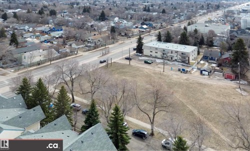 Aerial view highlighting the surrounding neighborhood, featuring residential properties, mature trees, and an extensive road network - 31 9914 80 Avenue, Edmonton, AB - Outdoor With View