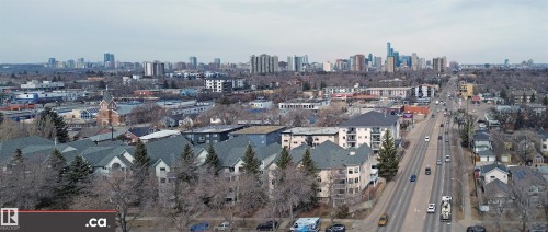 This aerial view highlights the neighborhood's proximity to a bustling urban center, featuring a variety of buildings and a prominent roadway - 31 9914 80 Avenue, Edmonton, AB - Outdoor With View