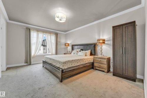 This room features light-colored walls and carpeted flooring - 32 1703 16 Avenue, Edmonton, AB - Indoor Photo Showing Bedroom