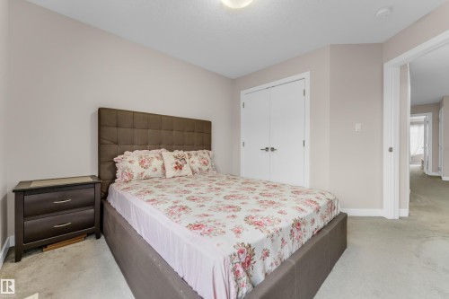 This inviting room features neutral-toned walls and carpeted flooring - 32 1703 16 Avenue, Edmonton, AB - Indoor Photo Showing Bedroom