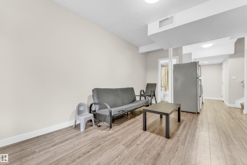 The property features light wood-style flooring throughout, neutral-toned walls, and recessed lighting - 32 1703 16 Avenue, Edmonton, AB - Indoor