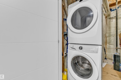 Laundry area with a white stackable washer and dryer - 32 1703 16 Avenue, Edmonton, AB - Indoor Photo Showing Laundry Room