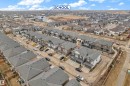 This property is situated within a developed residential community, featuring a clear view of a nearby school building - 32 1703 16 Avenue, Edmonton, AB  - Outdoor With View 