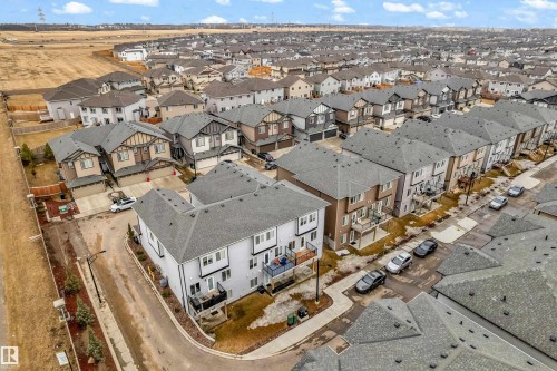 Aerial view of the property and its surrounding neighborhood, featuring a structured street layout with numerous residential homes - 32 1703 16 Avenue, Edmonton, AB - Outdoor With View