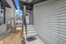 The property features a white door with windows, concrete steps, and a black handrail - 32 1703 16 Avenue, Edmonton, AB  - Outdoor With Exterior 