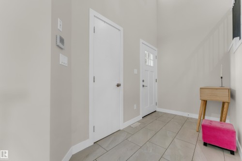 Entryway featuring light-colored walls, tile flooring, and a white front door with upper window panes - 32 1703 16 Avenue, Edmonton, AB - Indoor Photo Showing Other Room
