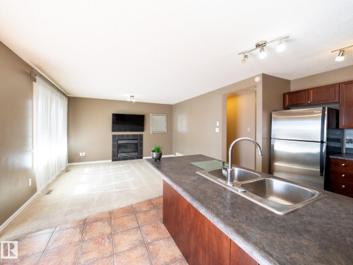 3617 Whitelaw Bay, Edmonton, AB - Indoor Photo Showing Kitchen With Fireplace With Double Sink