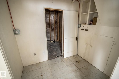 Utility area featuring white walls, a tiled floor, and built-in shelving - 5209 49 Ave, St. Paul Town, AB - Indoor Photo Showing Other Room