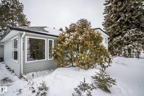 The property features light grey siding, white window trim, and a dark shingled roof - 5209 49 Ave, St. Paul Town, AB - Outdoor