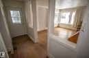 The property features an entryway with a white door, decorative glass inserts, and hardwood flooring - 5209 49 Ave, St. Paul Town, AB  - Indoor Photo Showing Other Room 