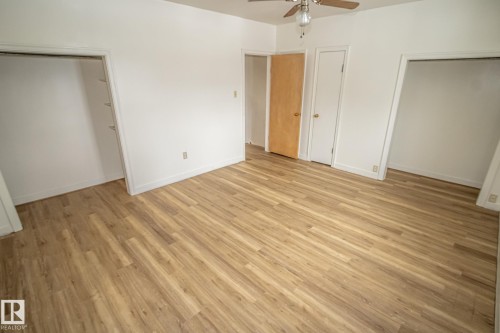This room features wood-style flooring and a ceiling fan - 5209 49 Ave, St. Paul Town, AB - Indoor Photo Showing Other Room