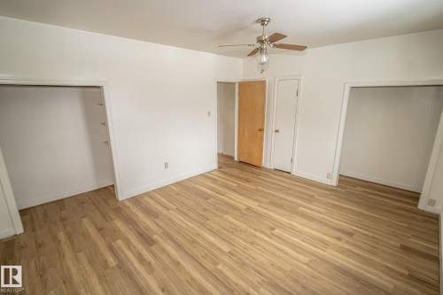 This room features light-colored flooring, a ceiling fan, and white walls - 5209 49 Ave, St. Paul Town, AB - Indoor Photo Showing Other Room