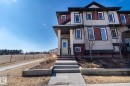 The property features a multi-story exterior with horizontal siding in varying shades, accented by dark trim around the windows and roofline - 1403 Cunningham Drive, Edmonton, AB  - Outdoor With Facade 