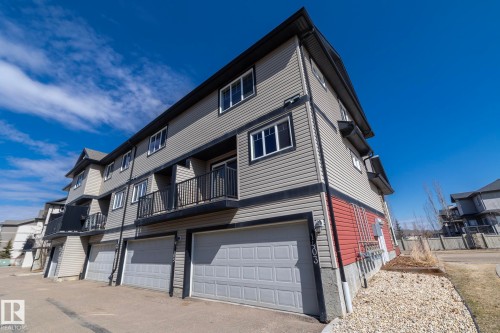 The property features a multi-story exterior with grey siding and dark trim - 1403 Cunningham Drive, Edmonton, AB - Outdoor