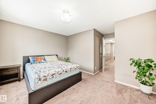 The property features neutral-toned walls, a ceiling light fixture, and carpeted flooring - 8 13838 166Ave, Edmonton, AB - Indoor Photo Showing Bedroom